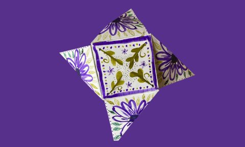 A Victorian puzzle purse on a purple background
